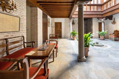 a room with a table and chairs in a building at Aljibe Rodrigo del Campo 1B in Granada
