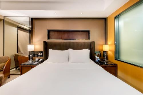 Ένα ή περισσότερα κρεβάτια σε δωμάτιο στο Celebrity Upper Class Hotel