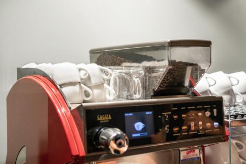 a toaster oven with a tray of dishes at Hotel all'Orso in Biancade