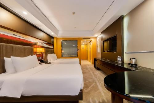 Ένα ή περισσότερα κρεβάτια σε δωμάτιο στο Celebrity Upper Class Hotel