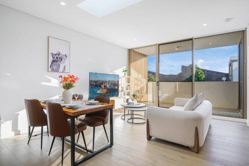 a living room with a table and chairs and a couch at Waterloo 1Br town close to Train Shopping in Sydney