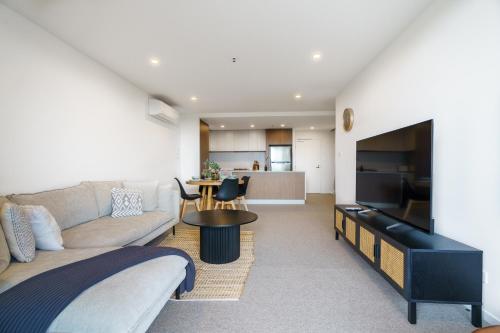 a living room with a couch and a table at Urban Apt in Phillip 9mins to Canberra Hospital - Hosted by Canstay in Phillip