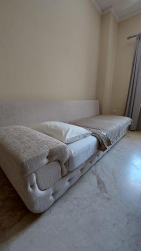a bed sitting on the floor in a room at SYRIOS House & Apartments in Nafplio