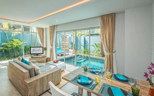 a living room with a swimming pool and a villa at Villa Sonata Phuket in Chalong 