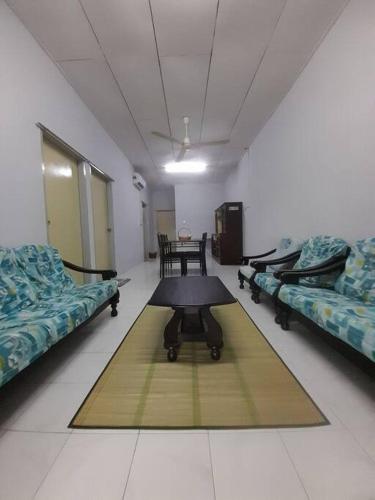 a hospital room with two beds and a table at Salaam Homestay Keningau in Keningau
