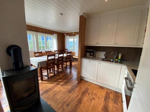 a kitchen and dining room with a table and chairs at Ruud Tun in Hafjell