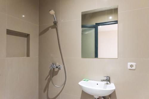 a bathroom with a shower and a sink at Mono Coliving Pakis, Surabaya in Wonokitri 2