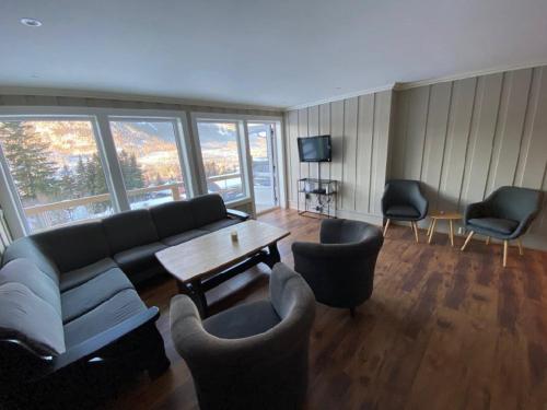 a living room with a couch and chairs and a table at Ruud Tun in Hafjell