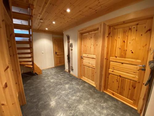 a large room with wooden walls and wooden doors at Ruud Tun in Hafjell
