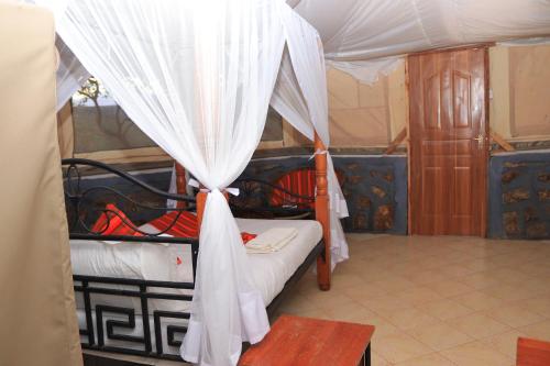 a room with two bunk beds with a canopy at ELANGATA OLERAI LUXURY TENTED CAMP in Narok