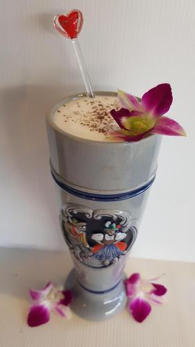 a drink in a cup with a spoon in it at Kasithorn Apartment's & Hotel in Phetchabun