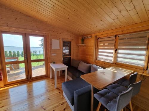 a living room with a table and a couch at Domki Gromadka in Wielen Zaobrzanski