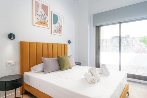 a bedroom with two beds and a large window at Myflats Campello Beach in El Campello