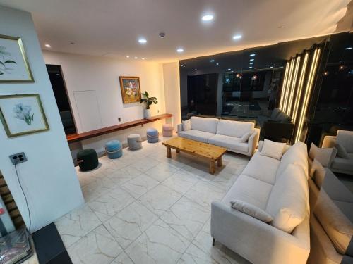 a living room with couches and a coffee table at Hotel Haema in Jeju