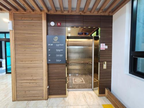 an entrance to a building with a revolving door at Hotel Haema in Jeju