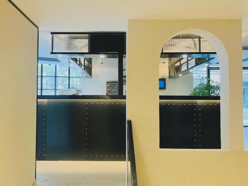 an entrance to an office with a black wall at Dayin Garden Hotel -People's Square & Nanjing Road-Large Social Area -Bar -Café -Gym -Free Laundry Luggage Storage -24H Front Desk-English Service in Shanghai