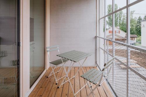 a porch with a bench and a table on a balcony at Uze Apartments in Uzwil SG in Uzwil
