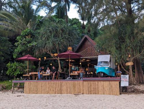 a restaurant on the beach with people sitting at tables at Ziggy Stardust in Ko Phayam