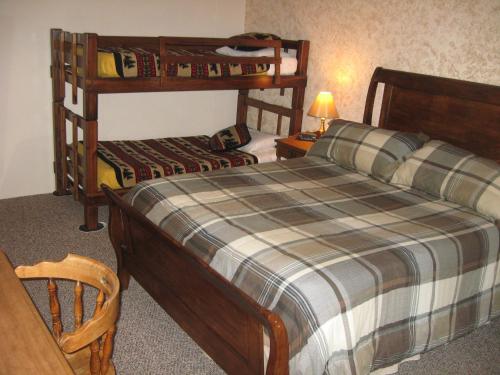 a bedroom with two bunk beds and a table at Big Bears Lodge in West Dover