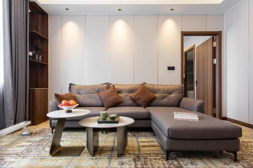 a living room with a couch and a table at Fortune Land Shenzhen in Shenzhen