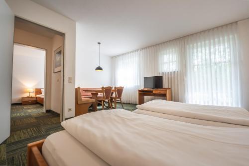 a hotel room with two beds and a desk at OG Ferienwohnung 4 Personen 2 in Rieden