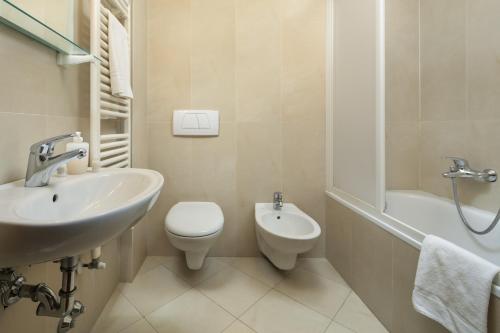 a white bathroom with a sink and a toilet at Antico Pastificio in Greve in Chianti