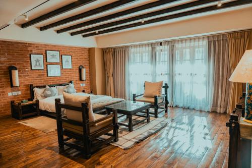 a living room with a bed and a table at Hotel Thamel House - 6 km from Boudhanath Stupa, Kathmandu in Kathmandu
