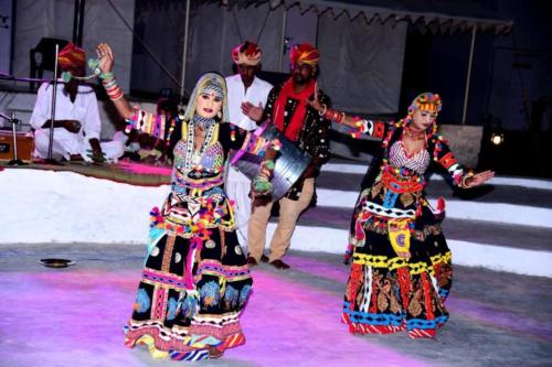 a group of people dancing on a stage at Aroma Desert Safari Camp in Sām