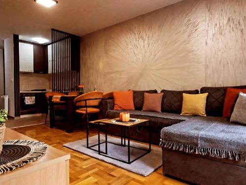a living room with a couch and a table at stan na dan AURORA in Požarevac