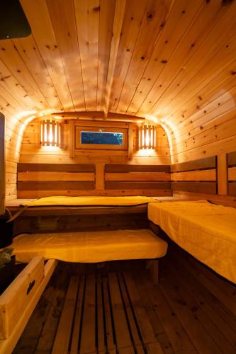 a sauna with two beds in a wooden room at EKVOLI MARINA VILLA,Isumi Garden in Chōjamachi