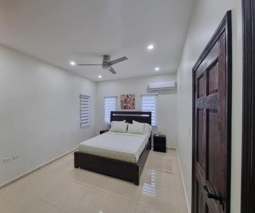 a bedroom with a bed and a ceiling fan at Condo with Pool - Sleeps 8 & bbq facilities in Philipsburg