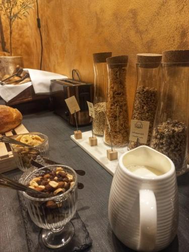 a table with jars of food and a bowl of nuts at Hotel Zuckerfabrik in Stuttgart