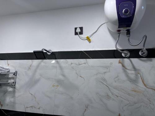 a bathroom with a marble counter with a hair dryer at Royal Galaxy Homes in Bhubaneshwar