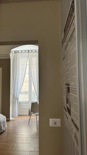 a room with a bed and a window and a wall at B&B Porta Baresana in Bitonto