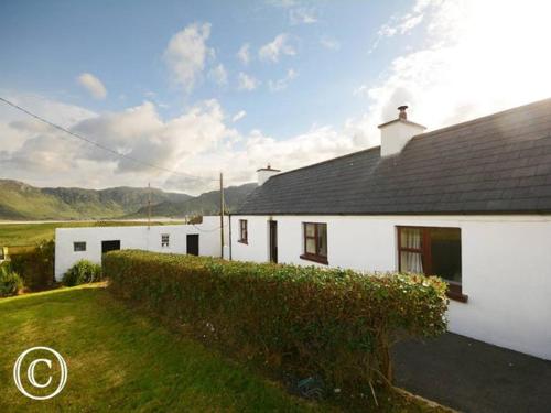 a white house with a hedge in front of it at Atlantic Coast in Ardara