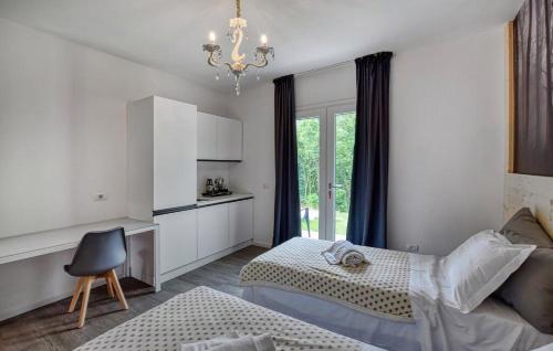 a bedroom with two beds and a chandelier at Dolce Bosco in Montebelluna