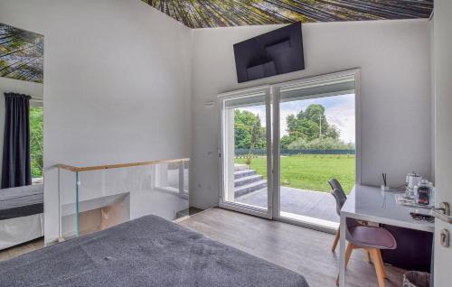 a bedroom with a bed and a desk and a window at Dolce Bosco in Montebelluna