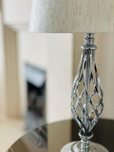 a clear glass lamp sitting on a table at Luxe Residences - Preston in Preston