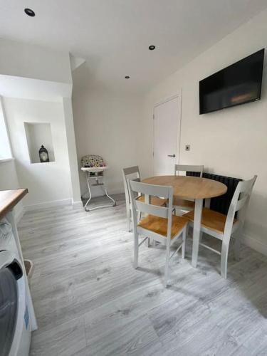 a dining room with a table and chairs at Luxe Residences - Preston in Preston