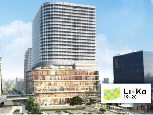a tall building with a sign in front of it at Canaan Chuocho Building A in Kagoshima