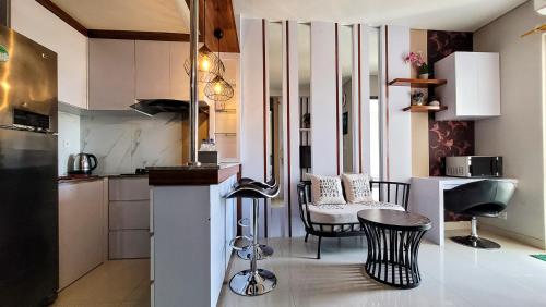 a kitchen with a table and chairs in a room at Palam Mansion at Apartment One Residence in Batam Center