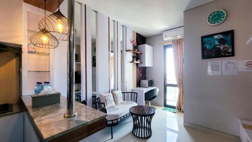 a living room with a table and chairs in a room at Palam Mansion at Apartment One Residence in Batam Center