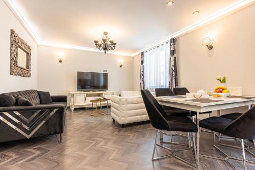 a living room with a table and a couch at Апартаменти Стефани in Plovdiv