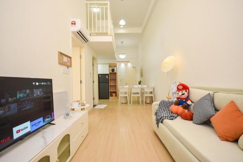 a living room with a couch and a flat screen tv at Sunway Grid Loft Suite by Nest Home【Olympic Size Pool】 in Kampong Pendas