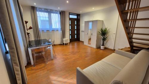 a living room with a couch and a piano at Casa via del Sale in Udine