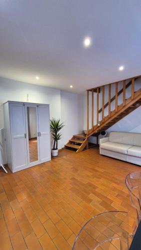 a living room with a couch and a staircase at Casa via del Sale in Udine