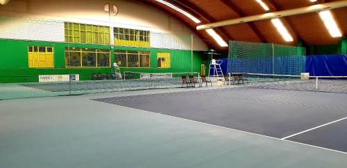 a tennis court in a building with a tennis court at Hotel Tennis Club in Prostějov
