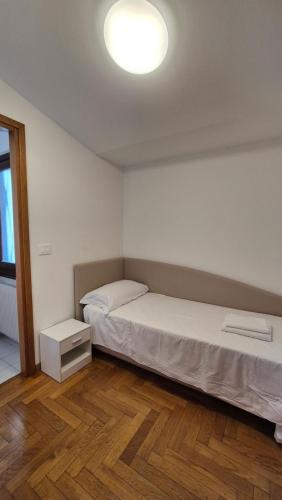 a bedroom with a bed and a light on the ceiling at Casa via del Sale in Udine