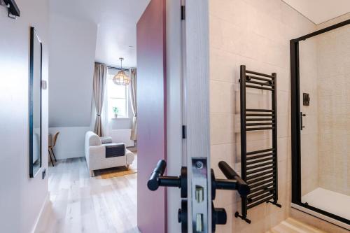 a living room with a pink door and a mirror at City Centre Apartment Free Parking and Luxury Finishes in Chester
