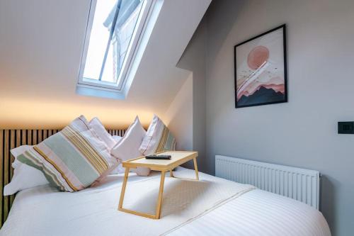 a bedroom with a bed with a table on it at City Centre Apartment Free Parking and Luxury Finishes in Chester